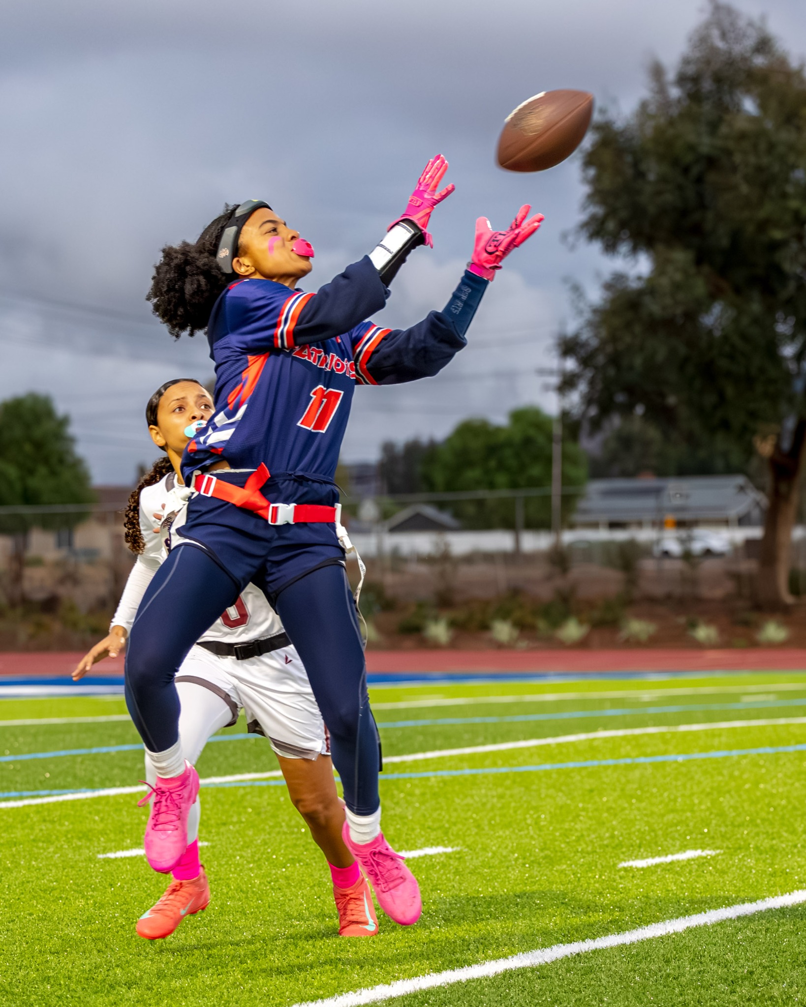 Flag football player reaching for a pass